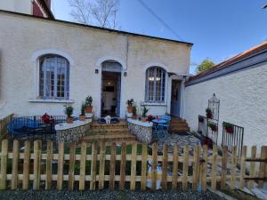 a white house with a wooden fence in front of it at Candy house in Salies-de-Béarn