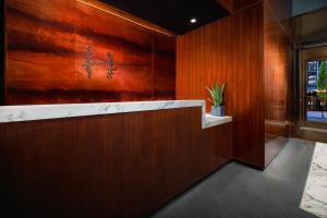 a lobby with a counter with a painting on the wall at Hotel Hendricks in New York