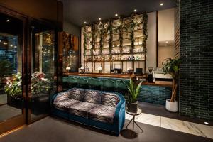 a bar with a couch in the middle of a room at Hotel Hendricks in New York
