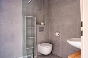 a bathroom with a toilet and a sink at La Casa Motel in Schaafheim +18 photos