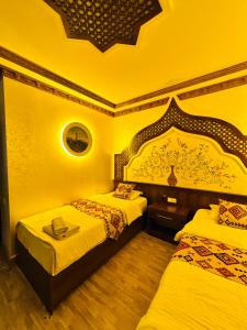 a hotel room with two beds in a room at Khiva Minor in Khiva