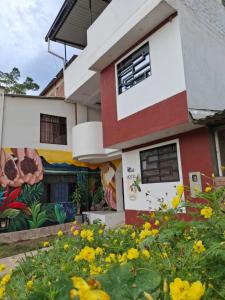 a house with a painting on the side of it at KOKOA GARDEN INN in San Vicente de Chucurí