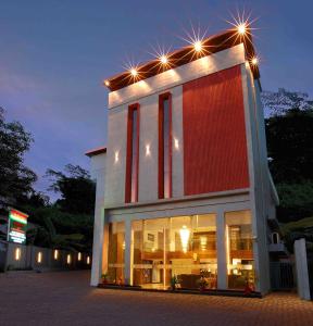 a building with lights on top of it at night at Hotel Indraprastha Karunagapally in Panmana