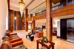 a large living room with couches and a table at Hotel Indraprastha Karunagapally in Panmana