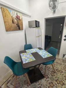 a kitchen with a table and chairs and a refrigerator at Coral Reef Charming studio by the three old cities in Cospicua