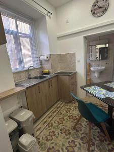 a bathroom with a sink and a toilet and a sink at Coral Reef Charming studio by the three old cities in Cospicua