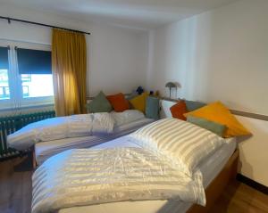 a bedroom with two beds and a window at Apartments Jäck in Sankt Englmar +39 photos