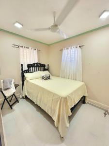a bedroom with a bed and a chair at Casa Mar y Campo in San Felipe de Puerto Plata