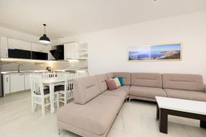 a living room with a couch and a table at Noa Apartments in Vlorë