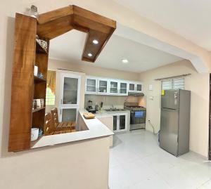 an open kitchen with a stainless steel refrigerator at Casa Mar y Campo in San Felipe de Puerto Plata