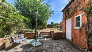 a patio with chairs and a white door at Northbrook in Tackley