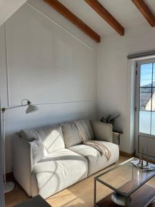 a living room with a white couch and a glass table at Bahía de Pedreña in Pedreña +10 photos