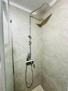 a shower with a shower head in a bathroom at Khiva Minor in Khiva