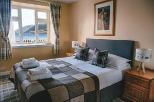 a bedroom with a bed with two pillows on it at Inn at Ardgour in Onich