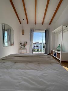 a bedroom with a large bed with a view of the ocean at Bahía de Pedreña in Pedreña