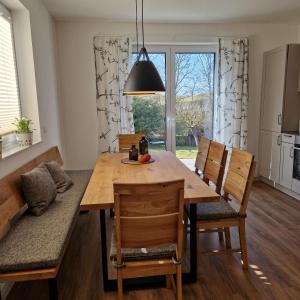 a kitchen and dining room with a table and chairs at Ferienhaus Marie in Wittenbeck