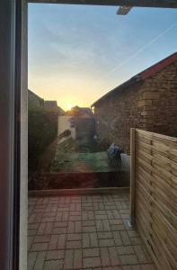 a view of the sunset from the outside of a house at Studio Margny in Margny