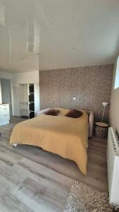 a bedroom with a large bed in a room at Studio Margny in Margny