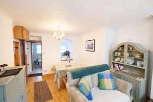 a living room with a couch and a table at Pen Llyn Quarryman's Cottage in Trevor +14 photos