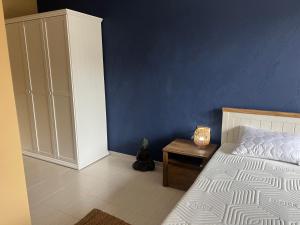 a bedroom with a bed and a blue wall at Apartment N 1 in Chernomorets