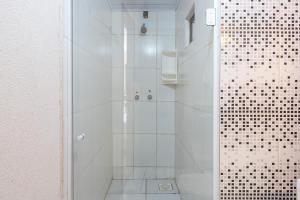 a bathroom with a shower with a glass door at Hotel Conexão in Penha +57 photos