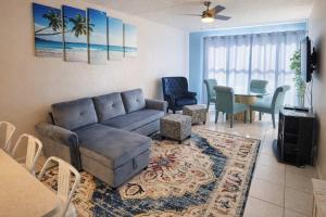 a living room with a couch and a table at Beach Access Condo with Pool, Hot Tub Area & BBQ - Gulfview I - unit 213 in South Padre Island