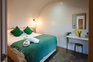 a bedroom with a bed with towels on it at Pheasant Lodge in Little Bytham