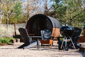 a group of chairs and a grill and a tent at Pheasant Lodge in Little Bytham