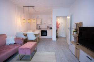 a living room and kitchen with a couch and a table at Signature Suites Sauerland in Winterberg