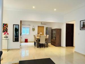 a dining room and living room with a table and chairs at Alima in Malabo