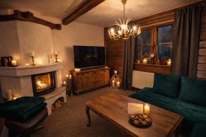 a living room with a couch and a fireplace at Rioba Chalet in Nová Bystrica