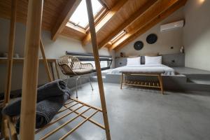 a bedroom with a bed and a chair at Evia Silence in Boufalo