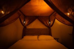 a bed in a tent with lights on it at Signature Suites Sauerland in Winterberg