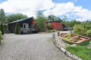 a house with a boat in front of it at Byre 2 In The Park in Callander
