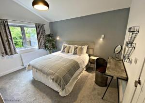 a bedroom with a bed and a window at Byre 2 In The Park in Callander
