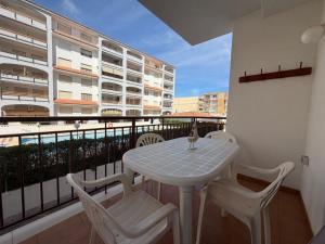 a white table and chairs on a balcony at Wimpy Solo Familias Serviplaya in Playa de Xeraco