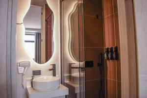 a bathroom with a sink and a mirror at Hotel Ryo 74B Suites by Growing Group in Medellín