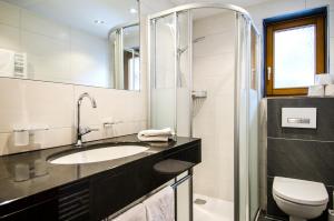 a bathroom with a sink and a toilet at Apart Bergblick in Ischgl +37 photos
