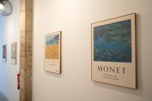 a group of posters on the wall of a museum at Baélia Experience Hotel boutique in Alicante