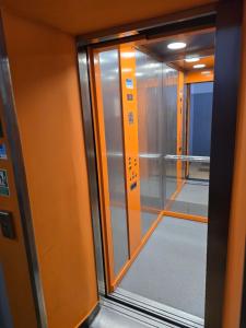 a glass door of an elevator with a window at Jasna Hotelik self check-in in Warsaw