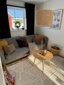 a living room with a couch and a table at Litet hus på landet in Krokom