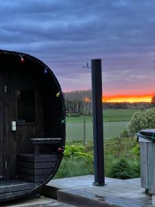 a round building with a sunset in the background at Pensionat på hästgård in Alunda