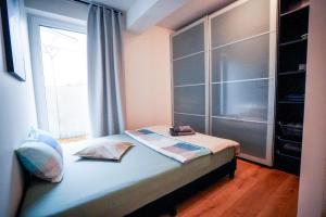 a bedroom with a bed with a large window at RheinView Residence - Apartment in Mainz