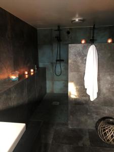 a bathroom with a shower with a white towel at Pensionat på hästgård in Alunda