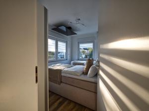 a bedroom with a dog sitting on a bed at Hermes Apartments Siebengebirge in Königswinter