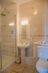 a bathroom with a sink and a shower and a toilet at Inn at Ardgour in Onich +75 photos