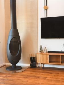 a living room with a black wood stove at Altitude Escape Retreat in Fundata