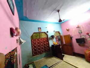 a room with pink and blue walls and a door at Dwivedi Nivas in Banda