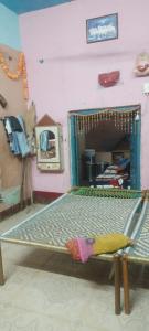 a bed in a room with a mirror at Dwivedi Nivas in Banda