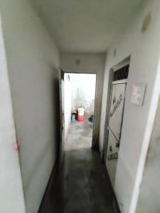 an empty hallway with a hallway leading into a room at Dwivedi Nivas in Banda